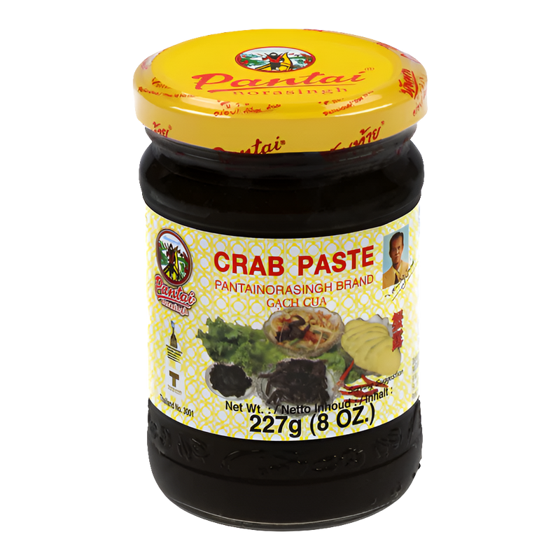 Jar of Pantai Norasingh brand fermented crab paste, 8 oz (227g), with a yellow lid and labeled in English and Thai.