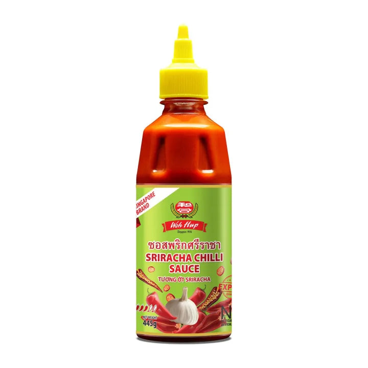 Bottle of Woh Hup Sriracha Chilli Sauce with a green label, yellow squeeze cap, and Thai chili pepper and garlic graphics