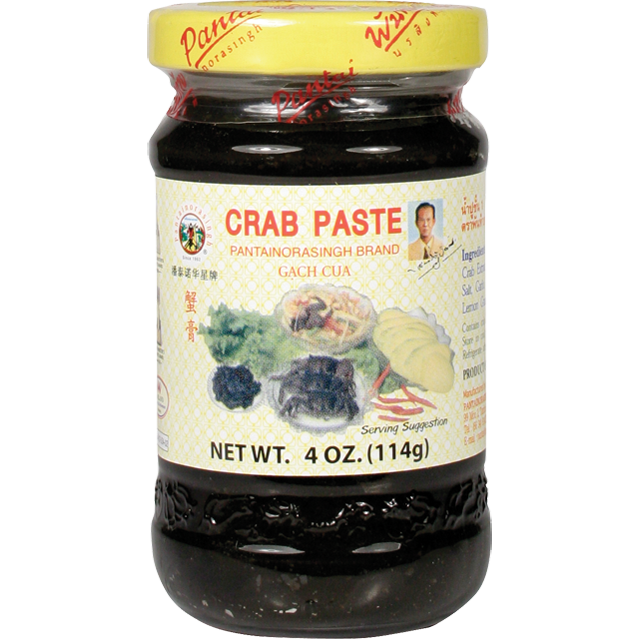 Glass jar of Pantai Norasingh brand fermented crab paste, 4 oz (114g), with a yellow lid and labeled in English and Thai.