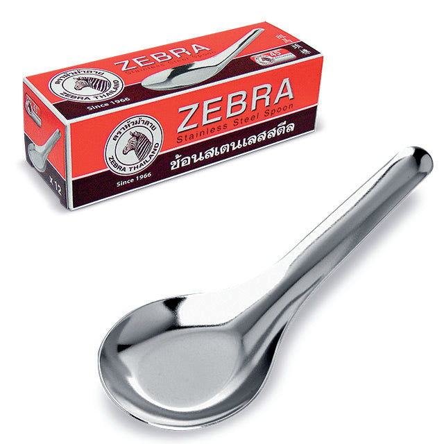 Zebra brand stainless steel soup spoon with a sleek, polished design, reflecting nostalgia at a Southeast Asian dinner table.